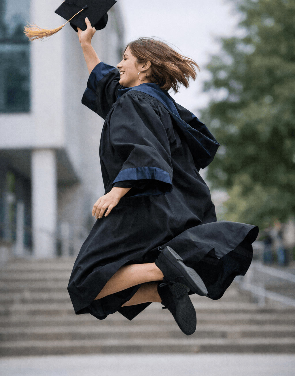 Graduate Jumping With Cap in Celebration