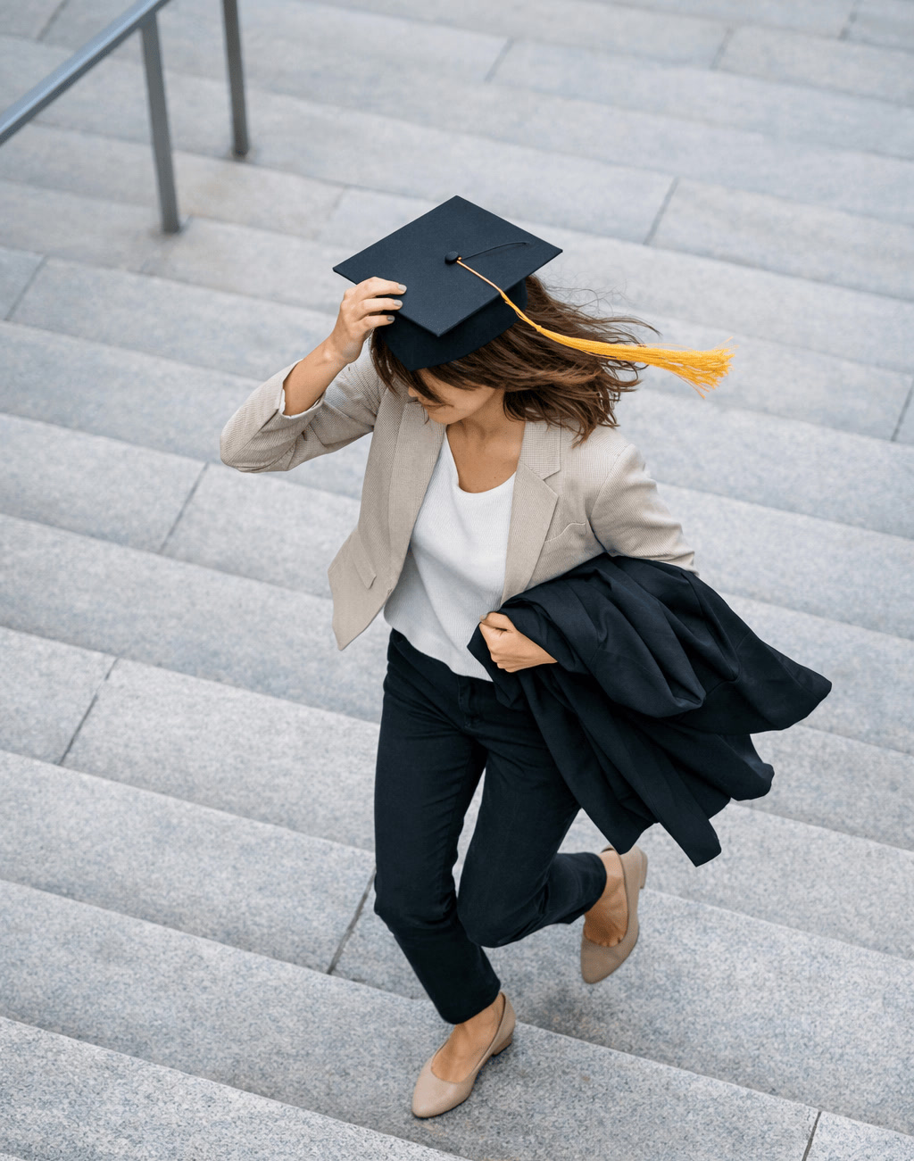 Woman Running Down Steps After Graduation