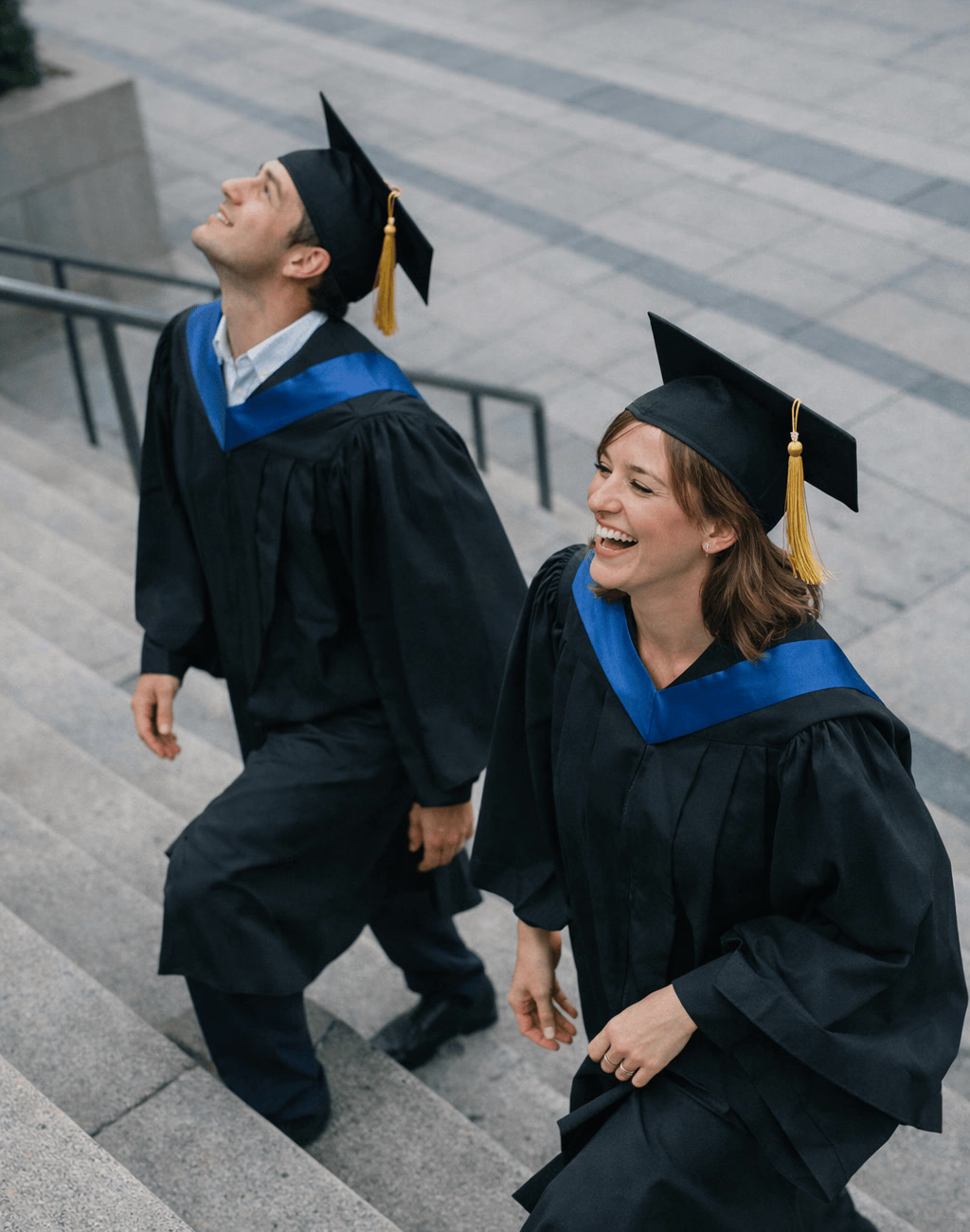 Two Graduates Walking Down Modern Stairs